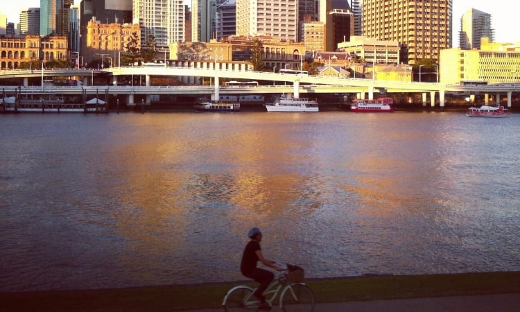 cyclist riding along the brisbane river